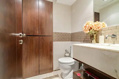a bathroom with a toilet and a sink at VayK - Chic 1BR with Marina View in Park Island in Dubai