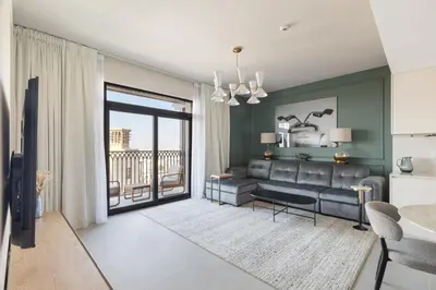 a living room with a couch and a table at Spacious 1BD, City View, Pool & Beach access in Dubai