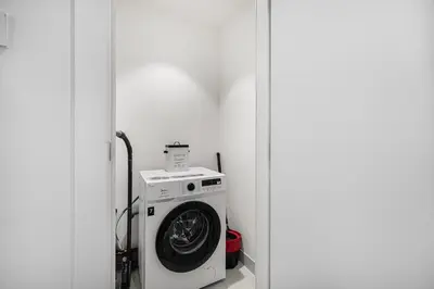 a washer and dryer in a corner of a room at Stylish Apartment - Private Beach - Port de La Mer in Dubai