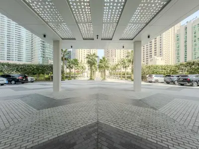 a view of a building with cars in a parking lot at Jumeirah Beach Residences Private Beach & Sea View in Dubai