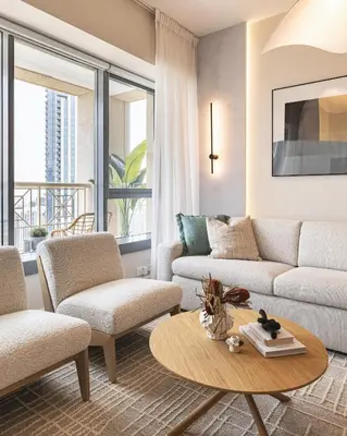 a living room with a couch and a table at The Burj View Suite Luxury 1BR Full Burj Views in Dubai