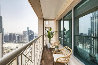 a balcony with chairs and a view of the city at The Burj View Suite Luxury 1BR Full Burj Views in Dubai
