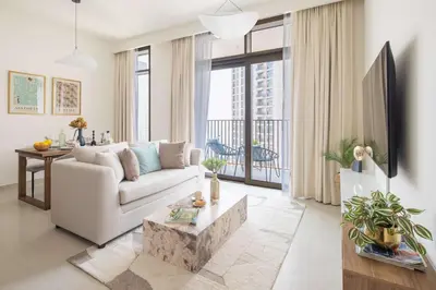 a living room with a white couch and a table at Frank Porter - Creek Palace in Dubai