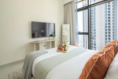 a bedroom with a large bed and a large window at Frank Porter - Creek Palace in Dubai
