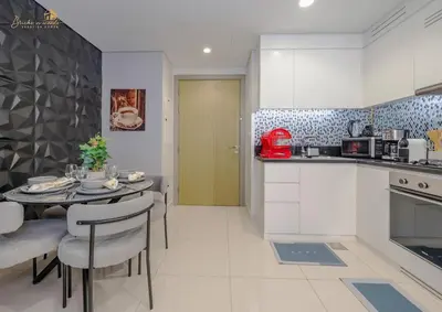 a kitchen and dining room with a table and chairs at Serene Canal View 2Bhk 6 pax in Dubai