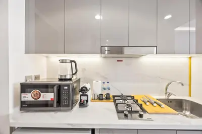 a kitchen with a counter top with a coffee maker at Elite Escape - Getaway in Azizi Riviera 13 in Dubai