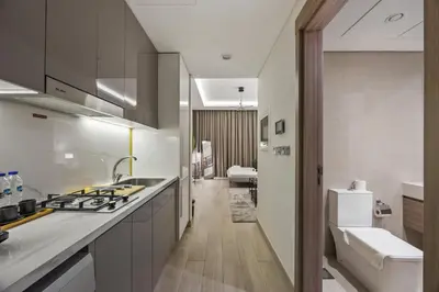 a kitchen with a sink and a stove top oven at Elite Escape - Getaway in Azizi Riviera 13 in Dubai