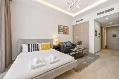 a bedroom with a bed and a living room at Elite Escape - Getaway in Azizi Riviera 13 in Dubai
