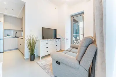 a living room with a chair and a tv at Short Walk to Marina Mall, Marina Walk and JBR Beach, Stunning Marina Views - Bay Central 2, Dubai Marina by Deluxe Holiday Homes in Dubai