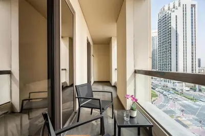 a balcony in a building with two chairs and a table at High-End Designer Stay l 4 Bed + Maids Room l JBR in Dubai