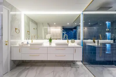 a bathroom with two sinks and a shower at High-End Designer Stay l 4 Bed + Maids Room l JBR in Dubai