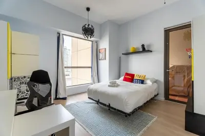 a bedroom with a bed and a desk and a window at High-End Designer Stay l 4 Bed + Maids Room l JBR in Dubai