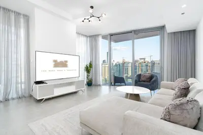 a living room with a couch and a tv at Elegant Living in the Heart of Dubai Marina in Dubai