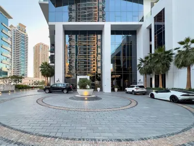 a large building with cars parked in front of it at Elegant Living in the Heart of Dubai Marina in Dubai