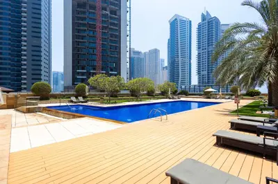 a swimming pool in a city with tall buildings at Marina Tower Residences by Baytna in Dubai