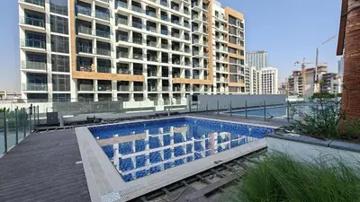 a swimming pool on the roof of a building at AirDXB - Chic Studio Apartment in Meydan Sleeps 2 with Balcony in Dubai
