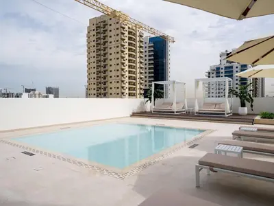 a swimming pool on the roof of a building at Abstract 1br Flair Gym Pool And Free Parking! in Dubai