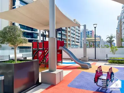 a playground with a slide and a slideintend at Serenity Studio with Balcony at Azizi Riviera in Dubai