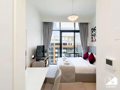 a hotel room with a bed and a balcony at Modern Comfort Studio Relax & Unwind in Style in Dubai