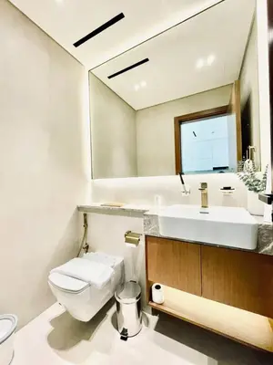a bathroom with a white toilet and a sink at Citylight 1br Escape Gym, Pool And Free Parking! in Dubai