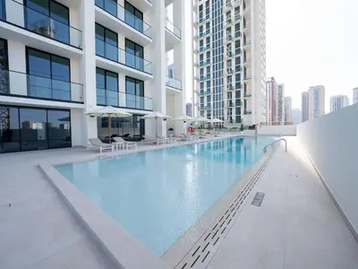 a large swimming pool in the middle of a building at Citylight 1br Escape Gym, Pool And Free Parking! in Dubai