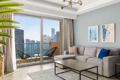a living room with a couch and a large window at Luxury in Dubai Marina Dining Pool Day & Beaches in Dubai
