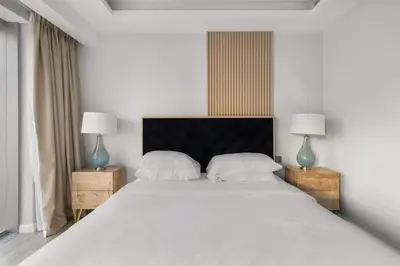 a bedroom with a large white bed with two lamps at Luxury in Dubai Marina Dining Pool Day & Beaches in Dubai