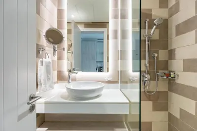 a bathroom with a sink and a shower at GuestReady – Infinity Pool and Beach l Palm in Dubai