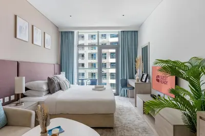 a hotel room with a bed and a large window at GuestReady – Infinity Pool and Beach l Palm in Dubai