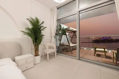 a living room with a view of a balcony at Unreal Patio Private beach Sea View 1BR in Dubai