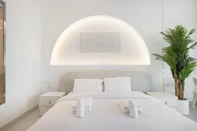 a white bedroom with a bed with white shoes on it at Unreal Patio Private beach Sea View 1BR in Dubai