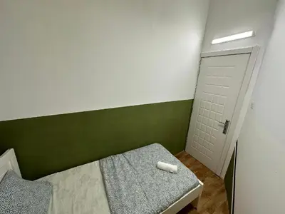 a small bedroom with a bed and a white door at Tourist Partition Room Barsha Heights Tecom in Dubai