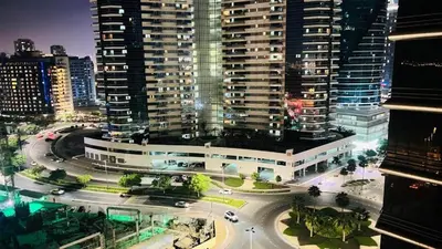 an aerial view of a city at night with buildings at Divine Partition Room Barsha Heights Tecom in Dubai