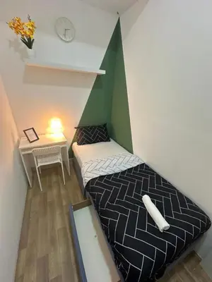 a small room with a bed and a table at Incredible Partition Room In Barsha Heights Tecom in Dubai