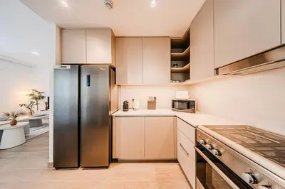 a kitchen with a stainless steel refrigerator at Spacious 3BD apartment at Creek Beach, Dubai in Dubai