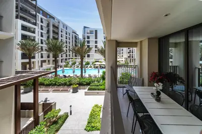 an apartment balcony with a view of a pool at Spacious 3BD apartment at Creek Beach, Dubai in Dubai
