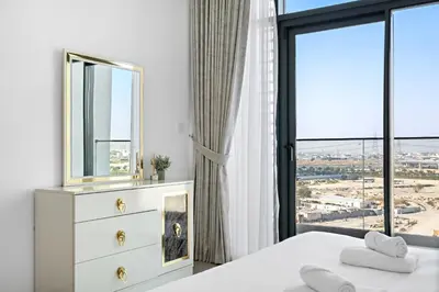 a bedroom with a bed and a mirror and a window at VayK - Large 1BR Near Hospital and Mall in Dubai