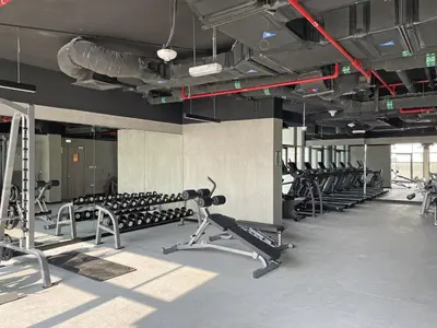 a gym with rows of exercise bikes and treadmills at VayK - Large 1BR Near Hospital and Mall in Dubai