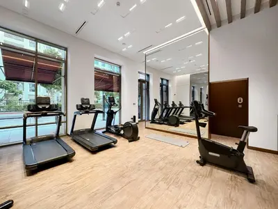a gym with several treadmills and elliptical machines at VayK - Classy 1BR Near the Lagoon in Creek Harbour in Dubai