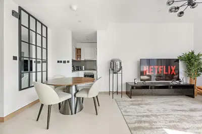 a kitchen and dining room with a table and chairs at VayK - Luxury 1BR with Marina View in Dubai