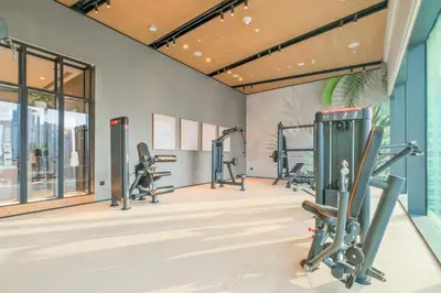 a gym with treadmills and elliptical machines at VayK - Luxury 1BR with Marina View in Dubai
