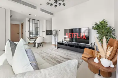 a living room with a couch and a tv at VayK - Luxury 1BR with Marina View in Dubai