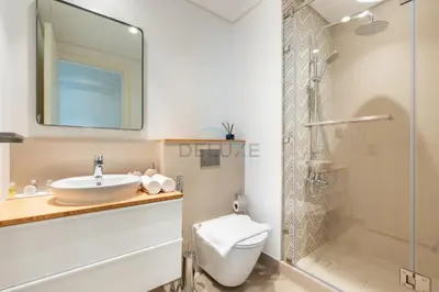 a bathroom with a toilet and a sink and a shower at Furnished 1BR Near Dubai Hills Park, Close to the Iconic Dubai Hills Mall, Only 15 Minutes from Burj Khalifa, Collective 20 Tower B, Dubai Hills by Deluxe Holiday Homes in Dubai