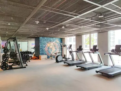 a gym with treadmills and elliptical machines at Furnished 1BR Near Dubai Hills Park, Close to the Iconic Dubai Hills Mall, Only 15 Minutes from Burj Khalifa, Collective 20 Tower B, Dubai Hills by Deluxe Holiday Homes in Dubai