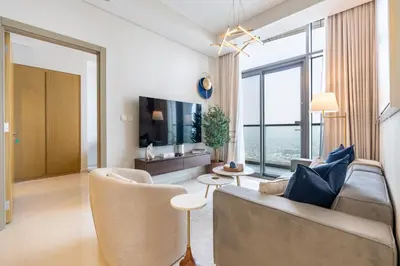 a living room with a couch and a tv at High-Floor Skyline View Near Safa Park and Godolphin Stables with Easy Access to Dubai Mall and Canal, Aykon City 2 Tower C, Business Bay by Deluxe Holiday Homes in Dubai