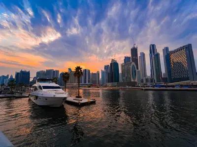 a boat docked in the water in front of a city at Savis Homes - The Voleo - Bright and elegant studio - Business Bay in Dubai in Dubai