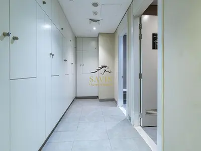 a hallway with white walls and a sign on the wall at Savis Homes - The Voleo - Bright and elegant studio - Business Bay in Dubai in Dubai
