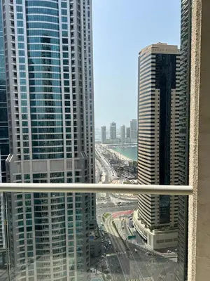 a view of a city from a window in a skyscraper at Luxury 2 BR Apartment Marina View in Dubai