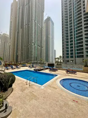 a swimming pool in a city with tall buildings at Luxury 2 BR Apartment Marina View in Dubai