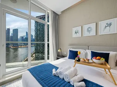 a hotel room with a bed with a large window at Livin' Holidays - Studio - Close to downtown in Dubai